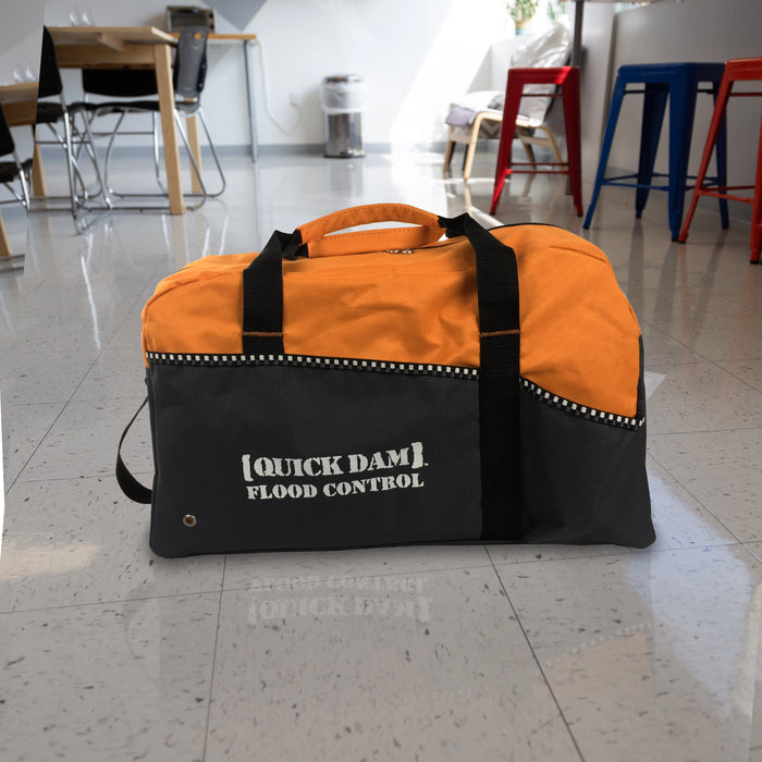 Quick Dam Flood Control duffle bag kit in orange and black, designed for portable storage and transport of water-activated flood protection products.
