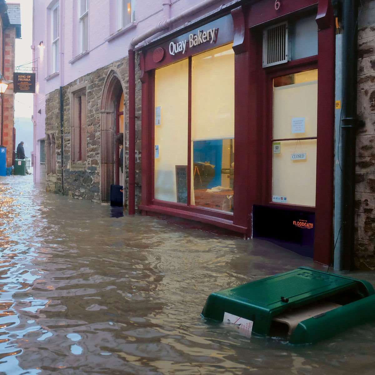 Quick Dam Flood Gate installed at bakery entrance, keeping floodwater from entering the storefront during heavy street flooding.