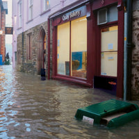 Quick Dam Flood Gate installed at bakery entrance, keeping floodwater from entering the storefront during heavy street flooding.