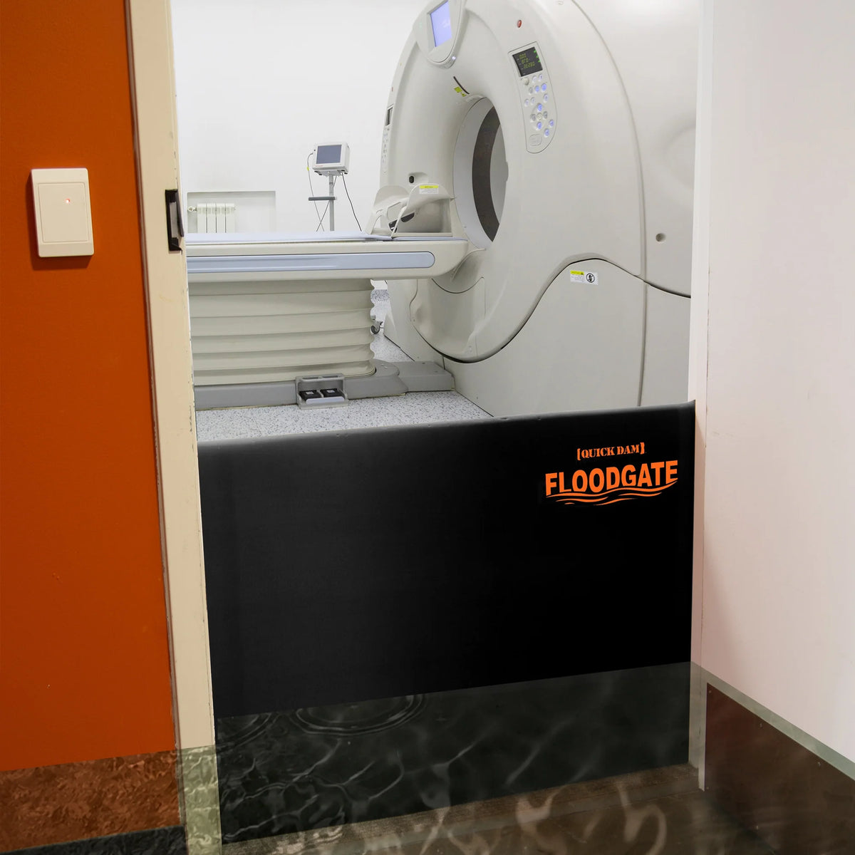 Quick Dam Flood Gate installed at the entrance of a hospital imaging room, blocking floodwater from entering and protecting critical medical equipment.