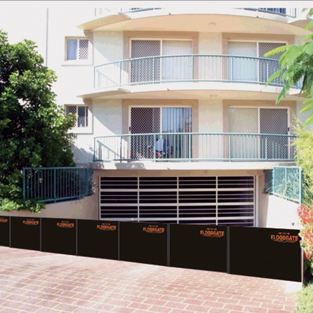 Multiple Quick Dam Flood Gates installed across an apartment building garage entrance providing strong flood protection for underground parking.