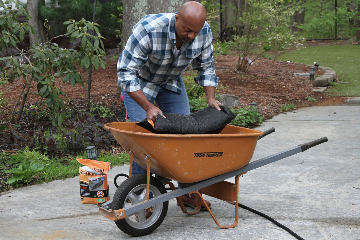 black flood bag in wheelbarrow