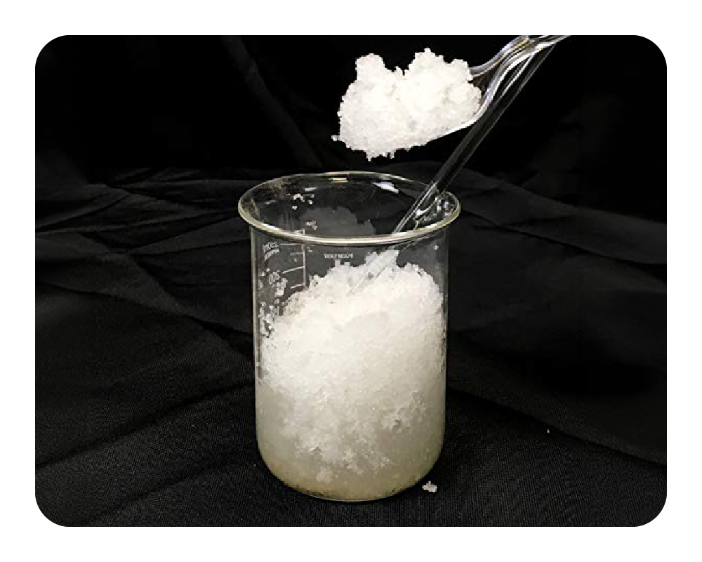 White Liquid Lock Powder being added to a beaker on a black background
