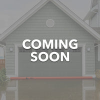 Log Dam COMING SOON displayed in front of a house with flood prevention measures