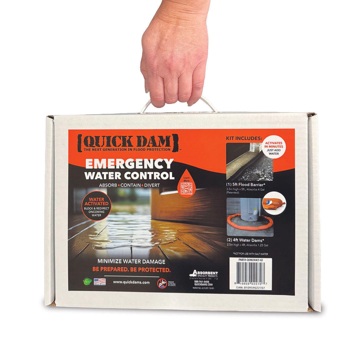 A hand holding a white cardboard box for Quick Dam Emergency Water Control, showing the front and side labels of the product packaging.
