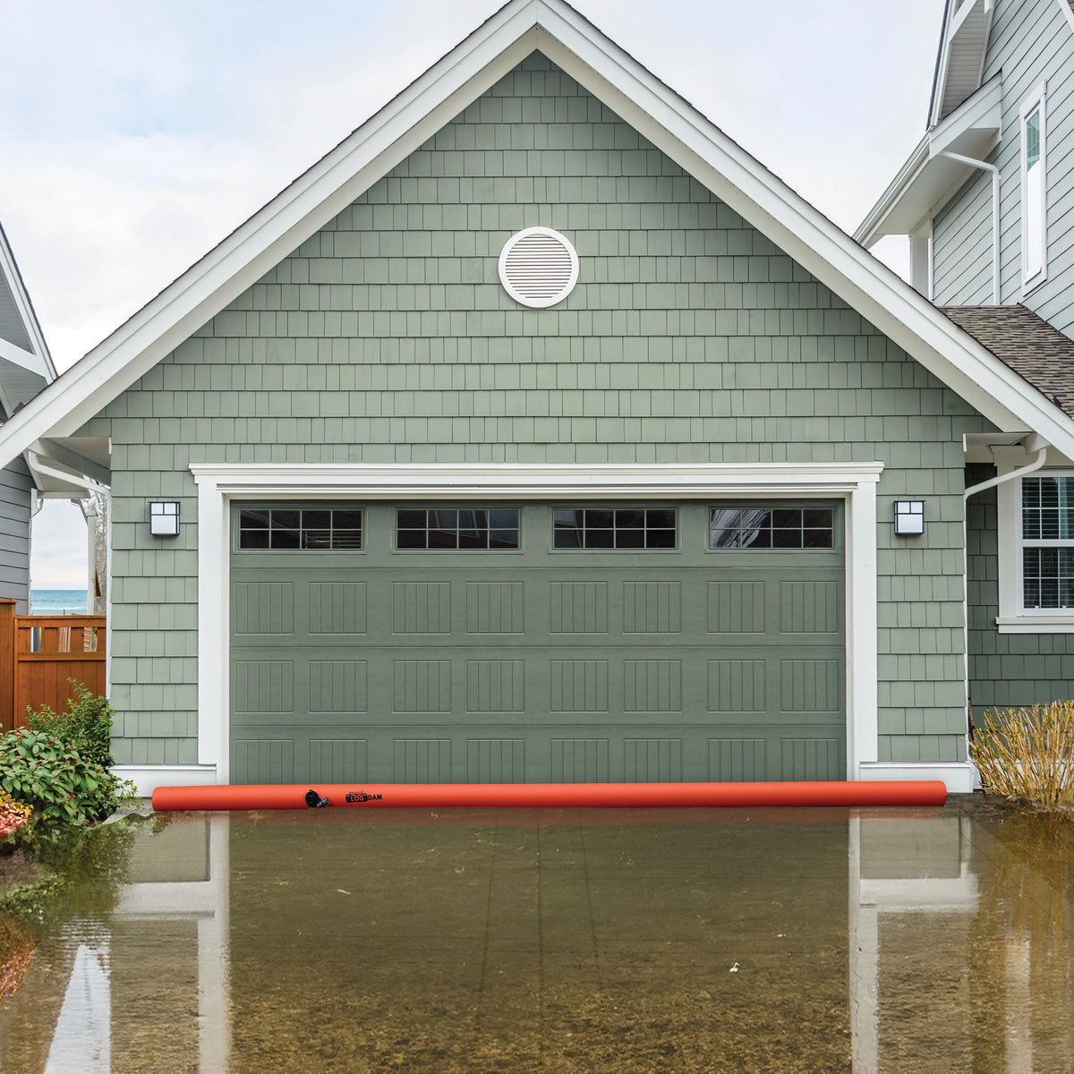 Log Dam (COMING SOON) placed in front of a garage to prevent water intrusion during flooding.