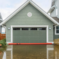 Log Dam (COMING SOON) placed in front of a garage to prevent water intrusion during flooding.