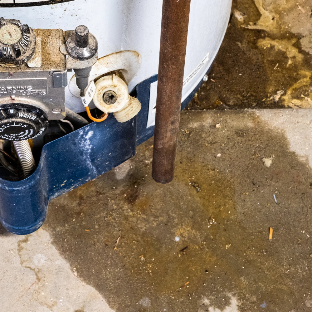 Close-up of a plumbing system with a pipe and valve on a concrete floor.