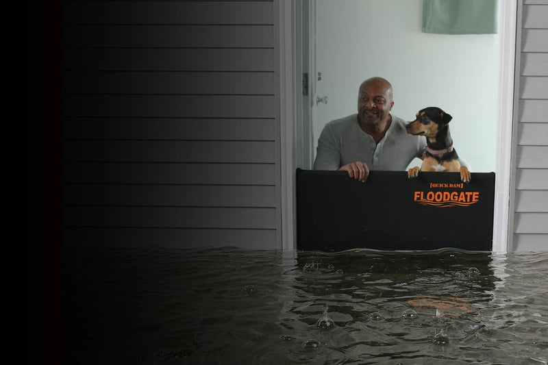 Man and dog using a Floodgate during a flood
