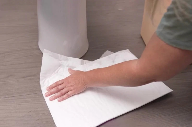 Mighty Mat wiping up spill on wood floor