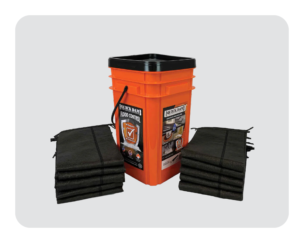 Orange bucket with flood barriers stacked on a white background