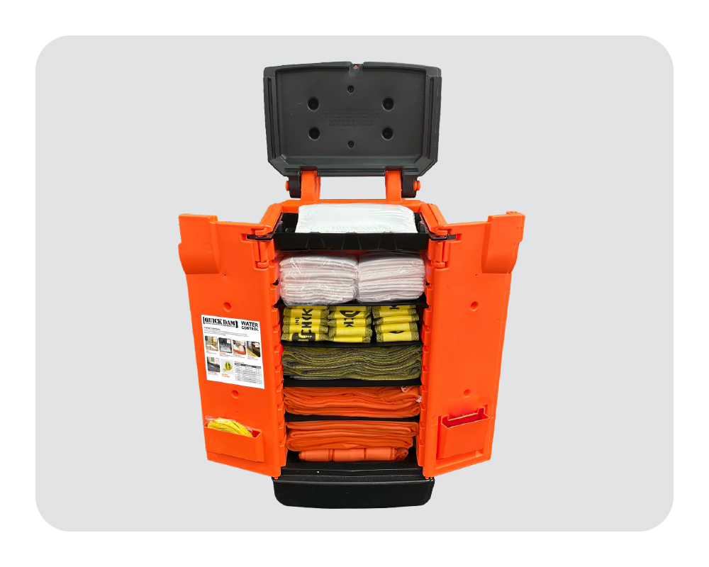 Orange and black quick dam caddy with flood control products on a white background
