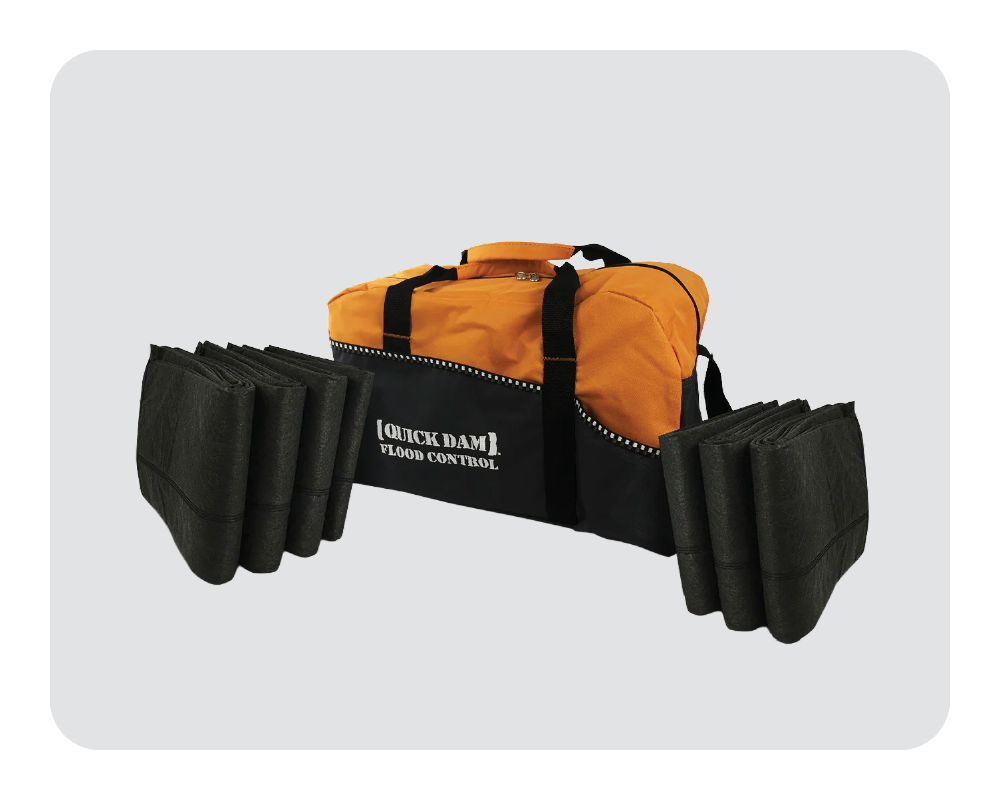 Orange and black flood control kit with Quick Dam branding on a white background