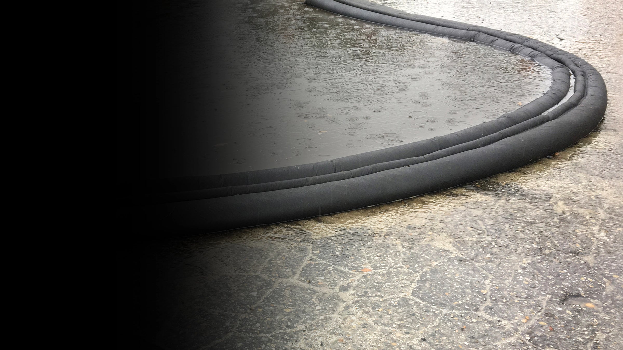 Close-up of a black flood barrier on outside pavement