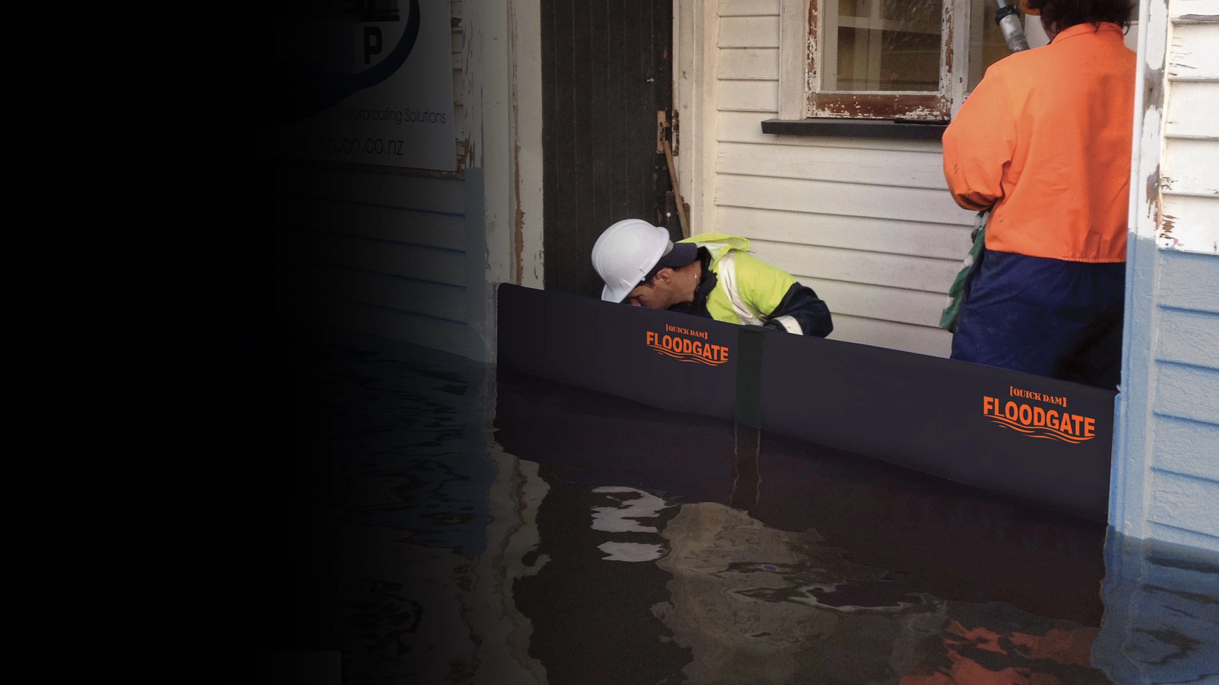 Person using a Flood Gate products to protect an entryway from floodwaters.