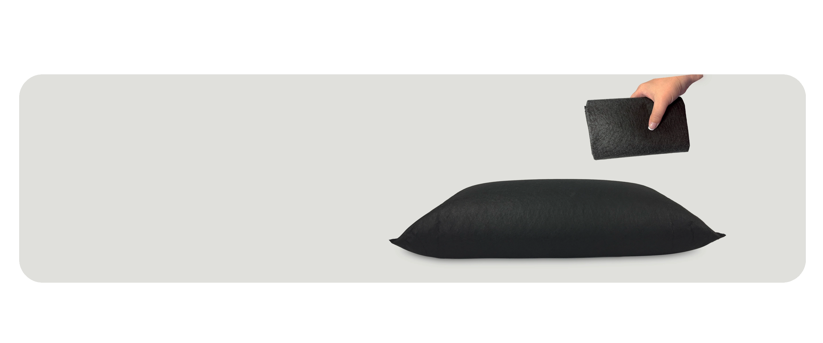 Hand holding a folded flood bag above an activated flood bag on light gray background