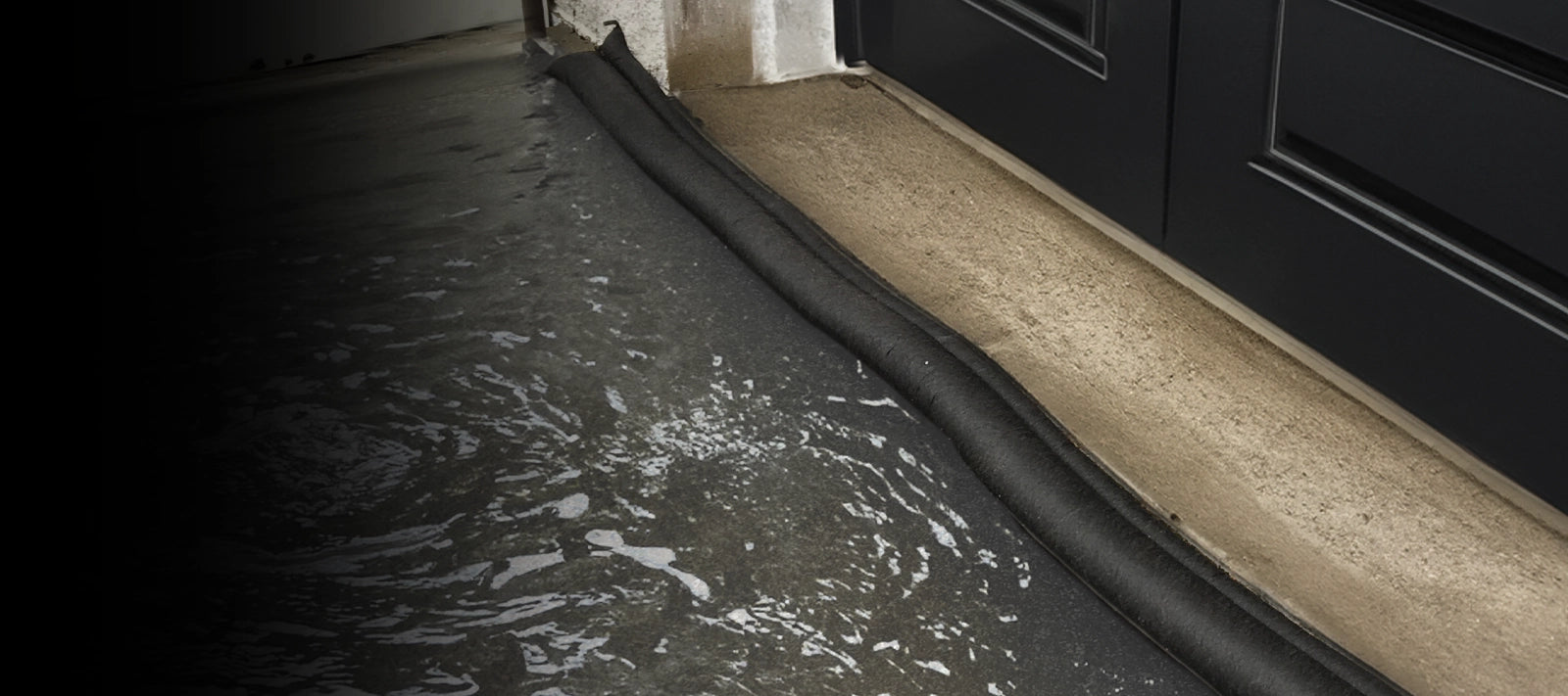 Garage door threshold with flood barrier holding back water