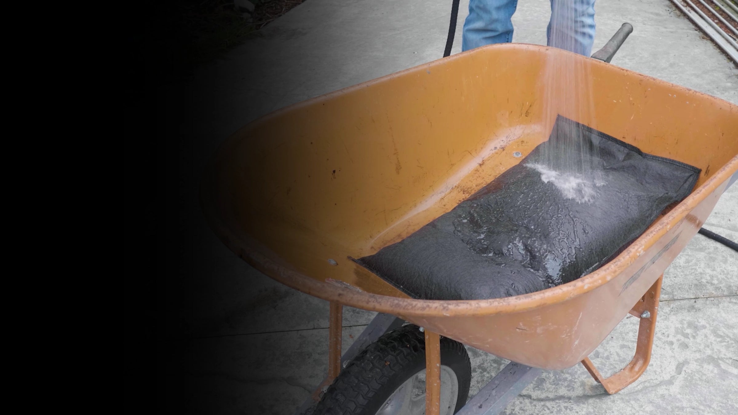 Wheelbarrow filled with water activating a flood bag
