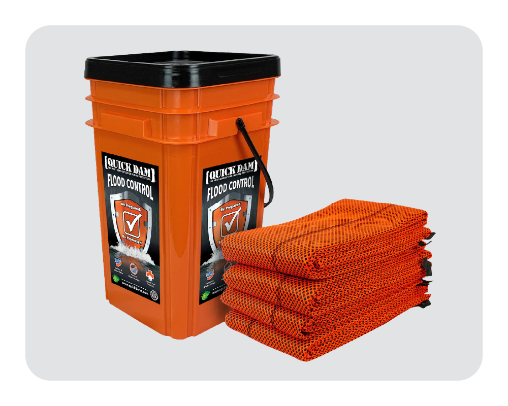 Orange bucket with 'Quick Dam' flood control product and multiple orange mats on a white background