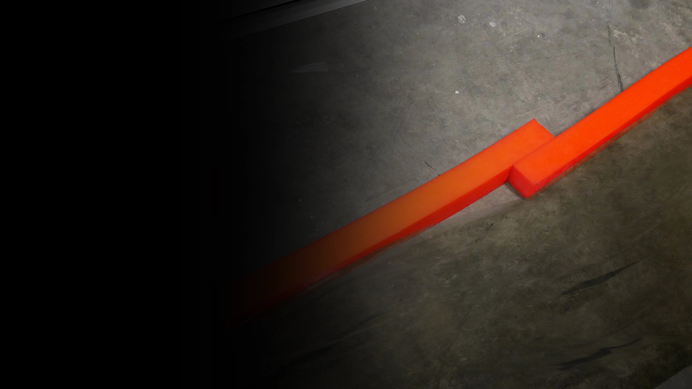 Two orange insta-dams overlapping on a dark textured surface