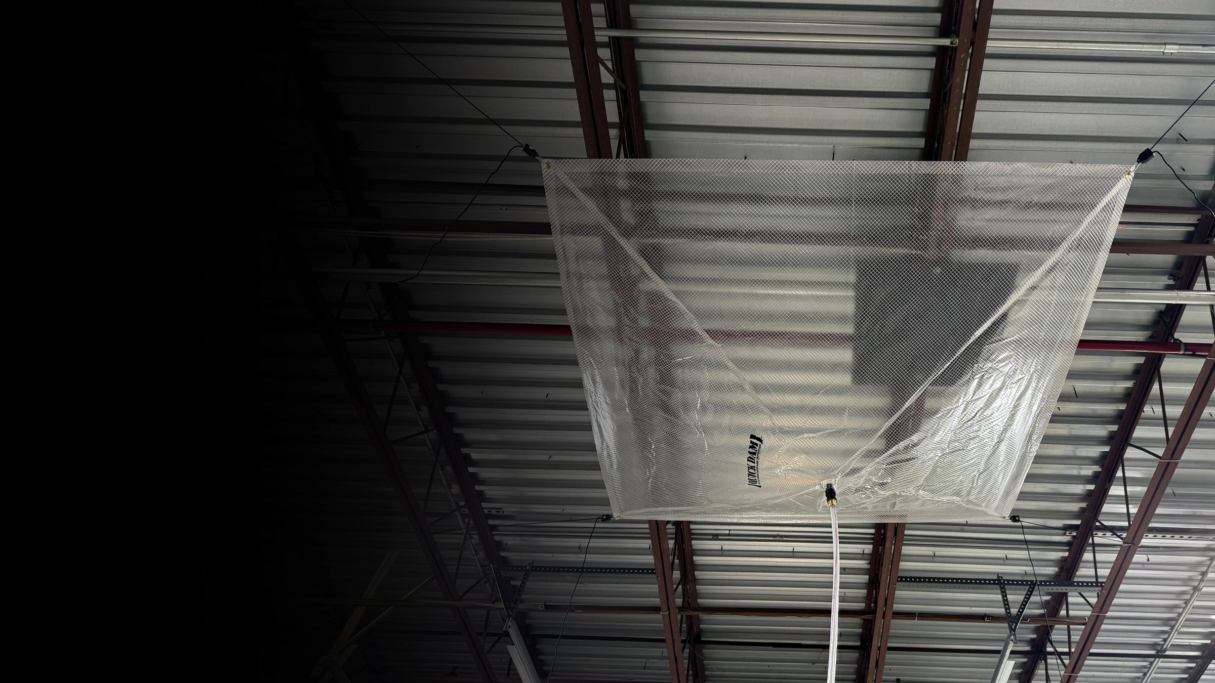 Ceiling-mounted leak diverter in an industrial setting.