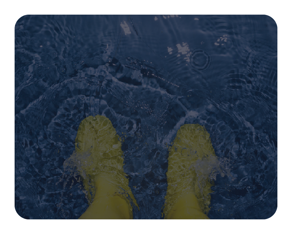 Yellow shoes splashing in blue water