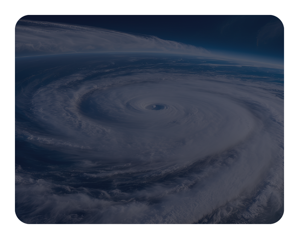 Hurricane viewed from space with swirling clouds and dark blue sky.