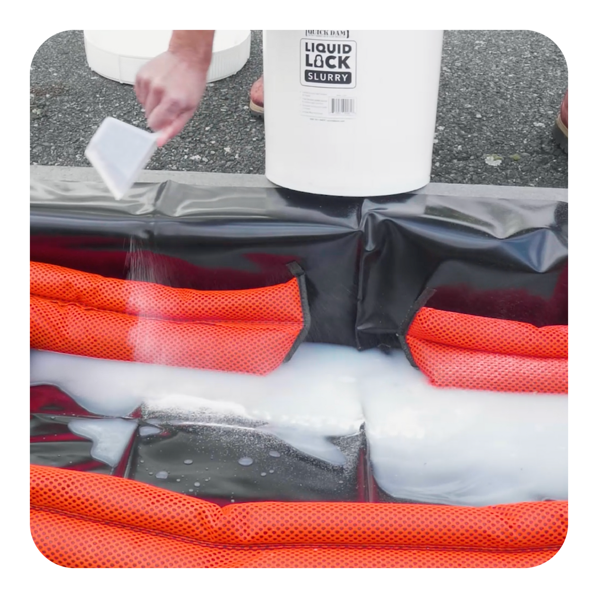 Quick Dam Hi-Vis Flood Barrier with Liquid Lock Slurry container in background