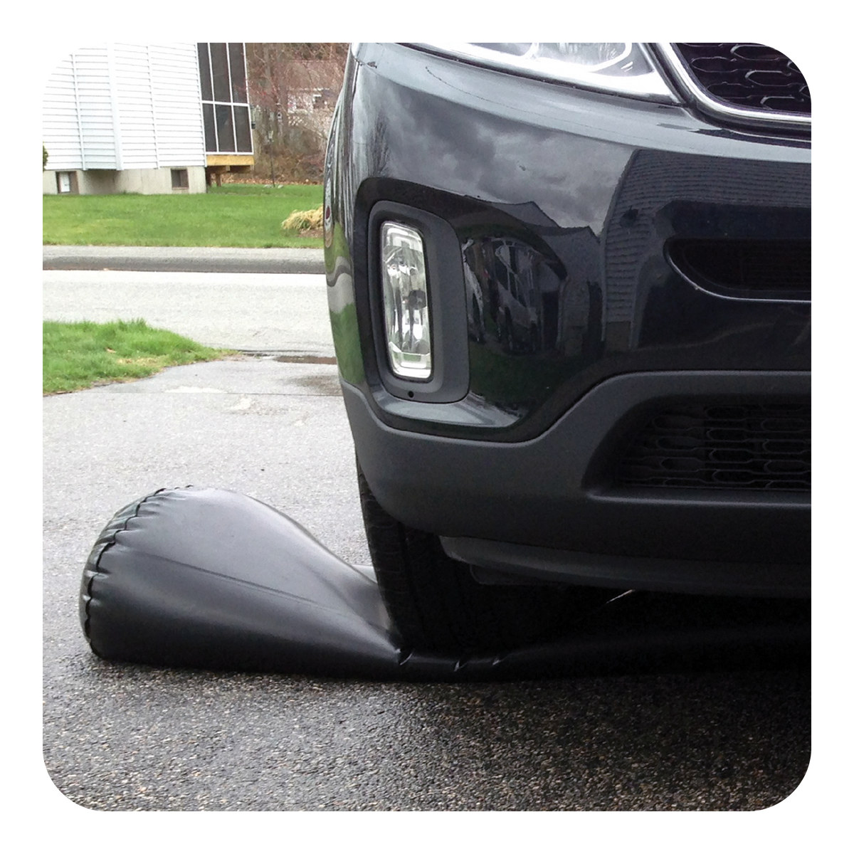 Car driving over a Water Curb in a driveway