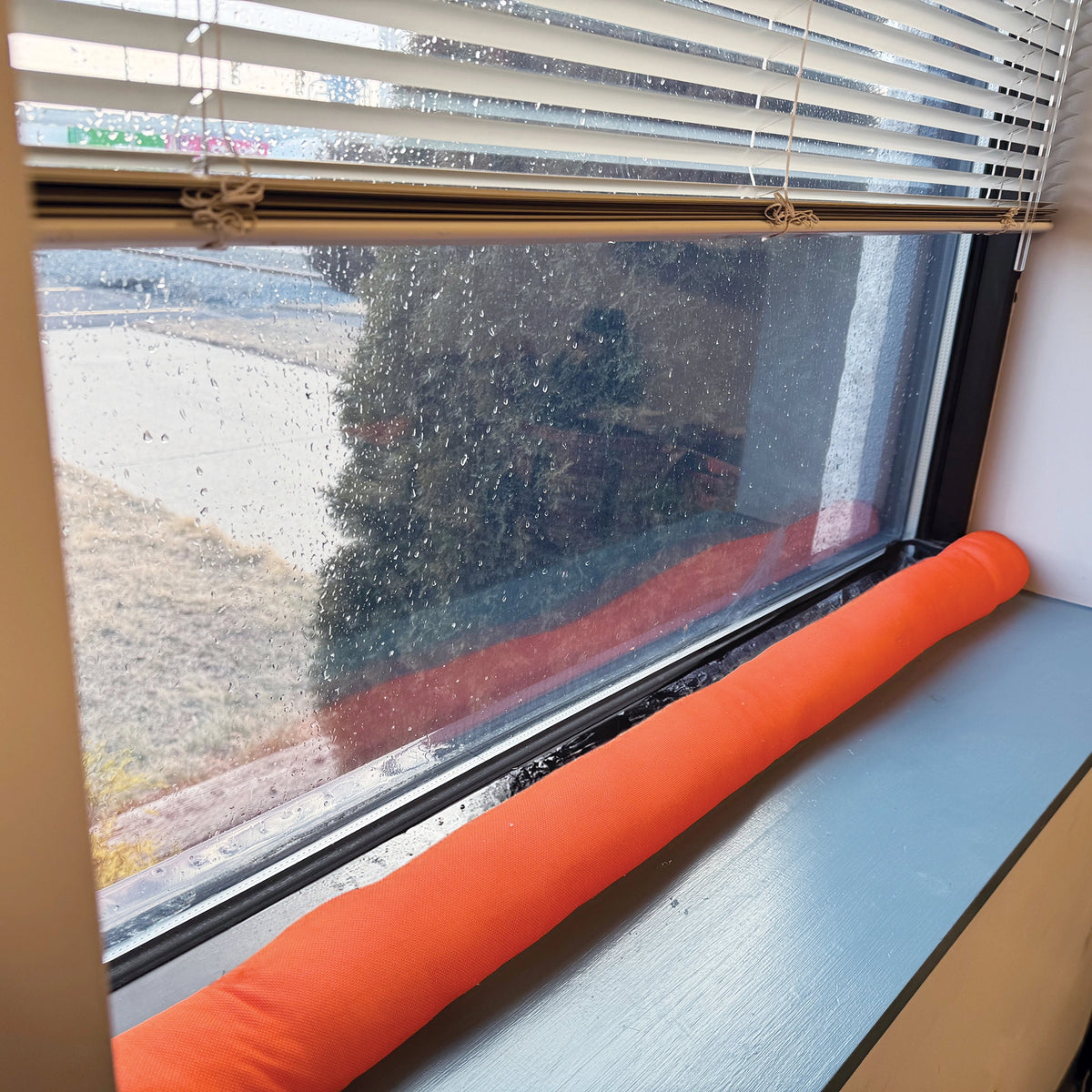 water dam on a window with raindrops on the glass
