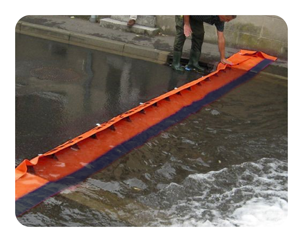 Orange water force barrier being used to contain water on a concrete surface.